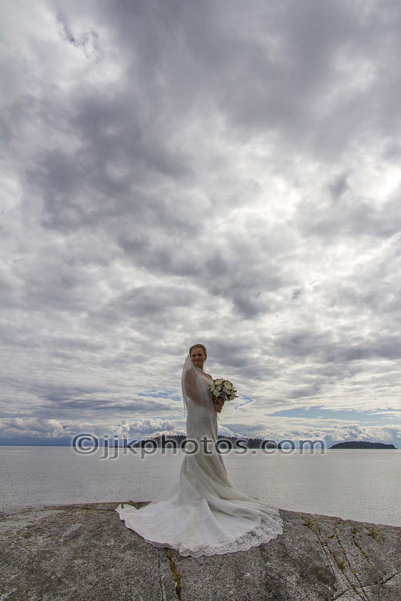 Bride on a rocky shoreline